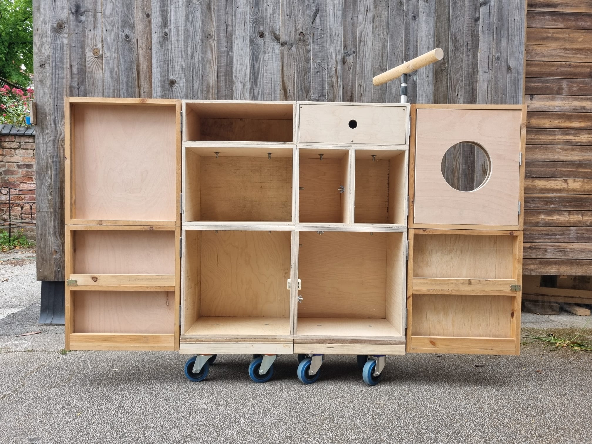 The final wooden cabinet with doors open before staining and fittings