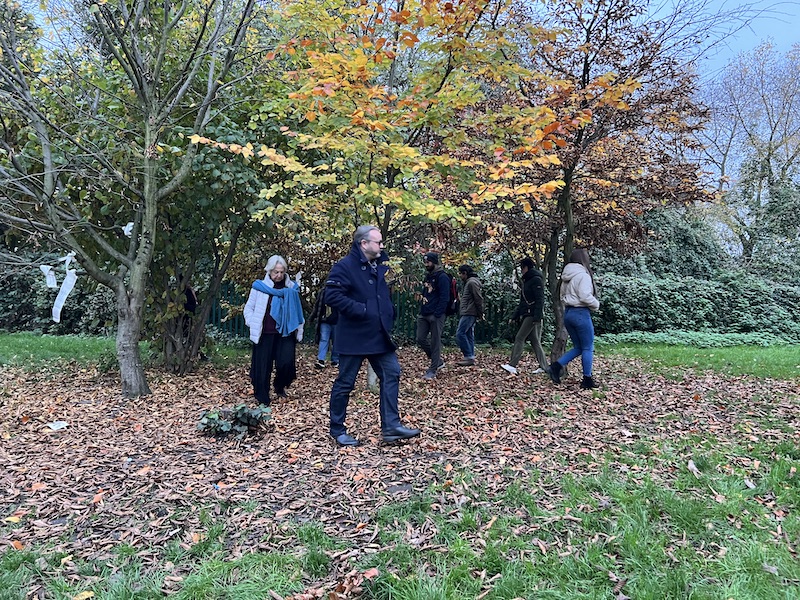 People walking around a tree in a circle.